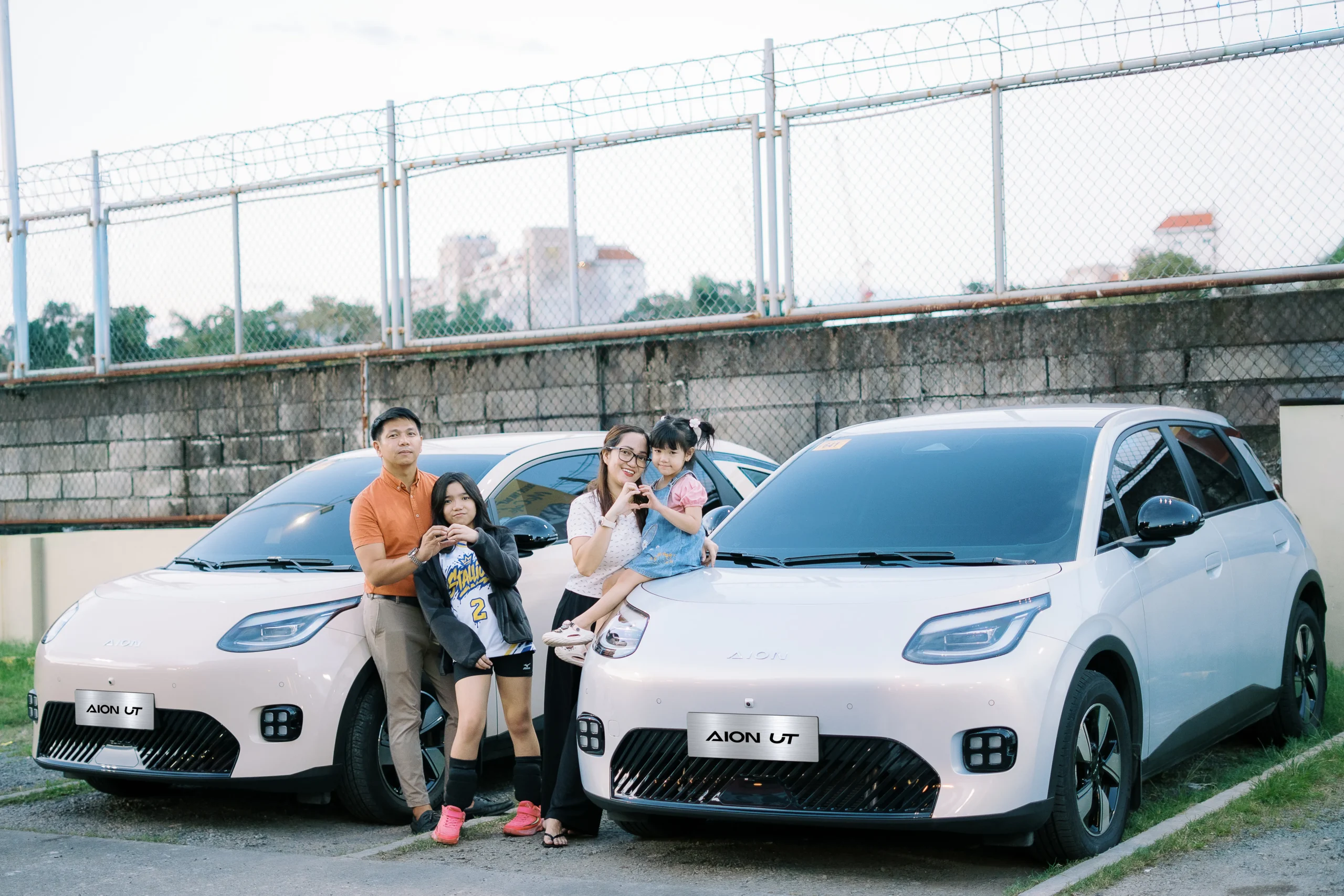 The Galang family with their GAC AION UT vehicles