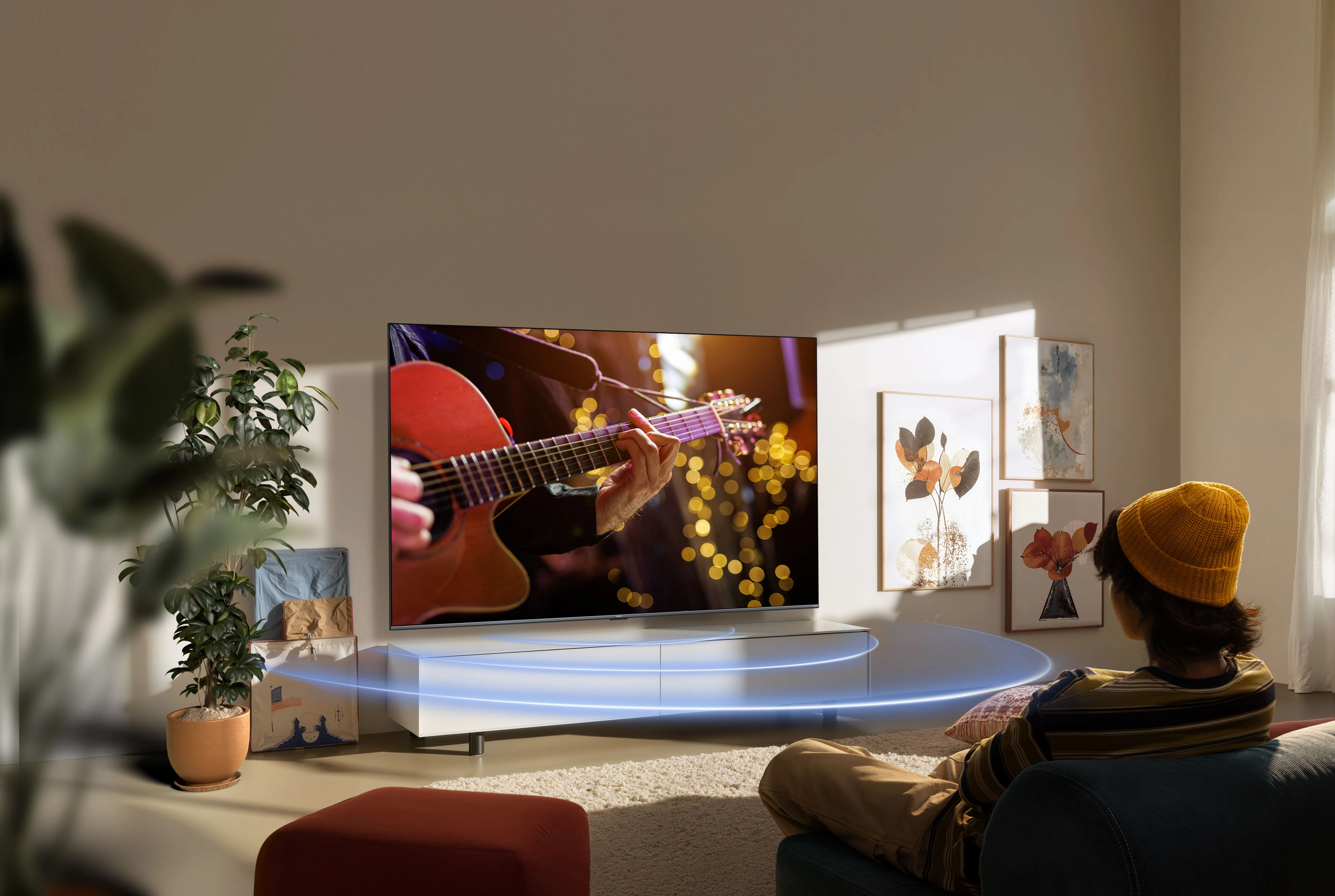 Viewer watching a guitarist on a Xiaomi TV S Mini LED 2026 television